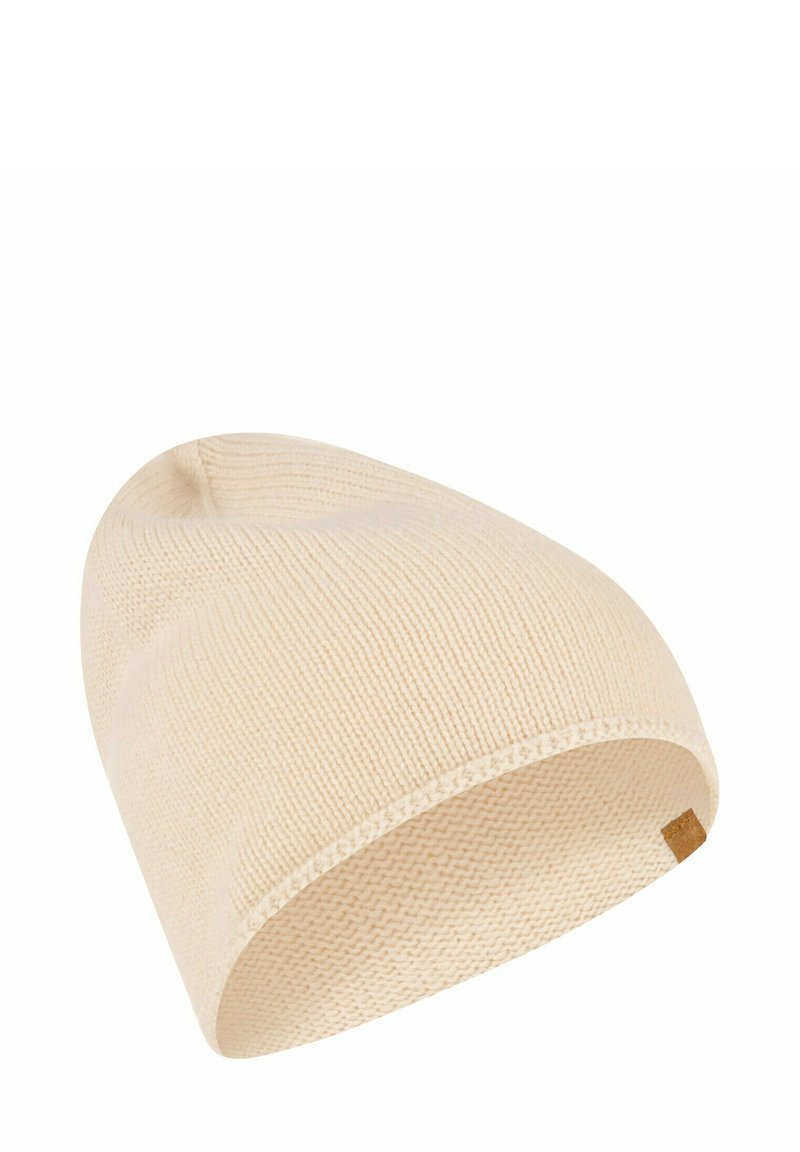 Cream-colored knit beanie with a smooth texture, tapered design, and a small brown leather tag accent on the side.