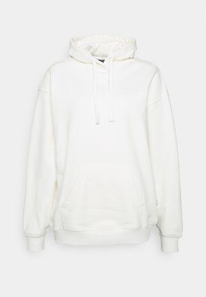 Bílé oversized mikina s klokaní kapsou a stahovací kapucí, s ribbovanými manžetami a lemem.