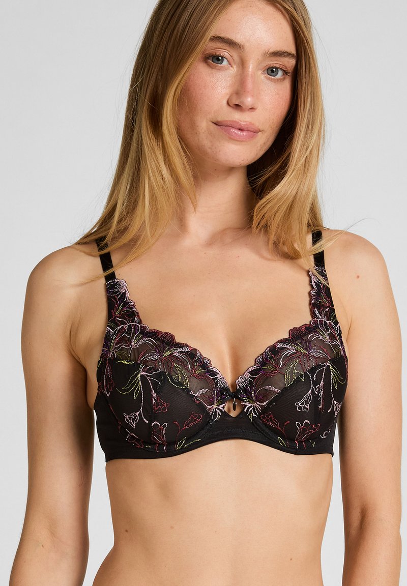Zwarte kanten bralette met bloemborduursel in paars, groen en roze. Heeft een gekartelde rand en een sleutelgatsluiting in het midden. Verstelbare bandjes.