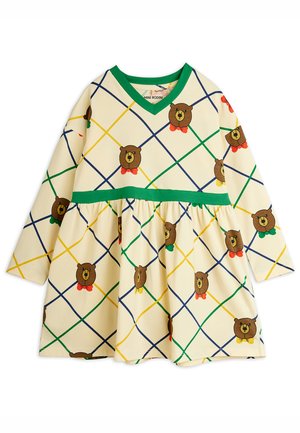 Vestido crema para niños con ribetes verdes y un patrón de cuadrícula diagonal multicolor que presenta caras de osos marrones llevando corbatas de lazo rojas, verdes o amarillas.
