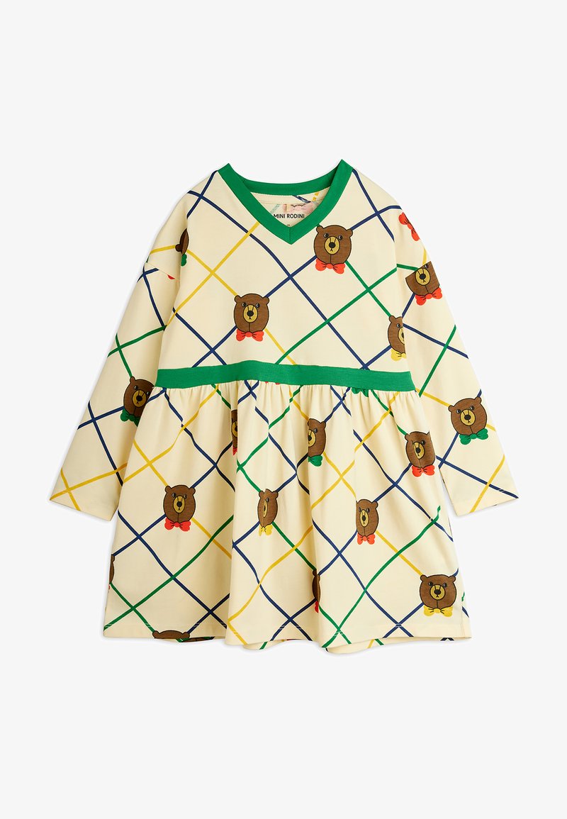 Krém színű gyerekruha zöld díszítéssel és színes, átlós rácsozatú mintával, amelyen barna medvefejek láthatók piros, zöld vagy sárga kötényekkel.