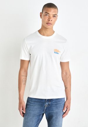 White cotton T-shirt with short sleeves and a round neckline. Features a colorful hand graphic and logo on the left chest. Standard fit.