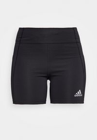 Mustat urheilusortsit, joissa on tiukka muotoilu, valmistettu joustavasta materiaalista. Ominaisuuksiin kuuluu korkea vyötärö ja valkoinen Adidas-logo.