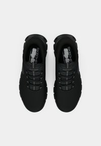 Coppia di scarpe da ginnastica Skechers nere senza lacci con stringhe elastiche, tomaia in mesh strutturato e suole imbottite, viste dall'alto.