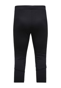 Schwarze Stretch-Leggings mit enganliegendem Schnitt, knöchellang, glatter Textur und flachen Nähten. Keine sichtbaren Muster oder Hardware-Details.