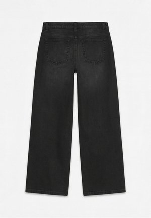 Melnas platas kājas džinsi, redzami no aizmugures, ar jostas cilpām, divām aizmugures kabatām un augstu vidukļa dizainu uz vienkārša fona.