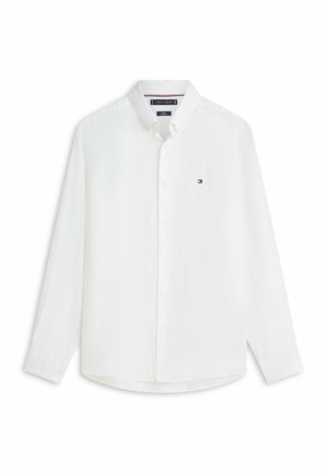 Camicia bianca a maniche lunghe con bottoni e colletto, piccolo logo Tommy Hilfiger sul lato sinistro del petto e polsini con bottoni.