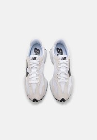 White and gray athletic shoes with mesh and suede materials, round toe, lace-up design, and a black accent on the side. Black outsole.