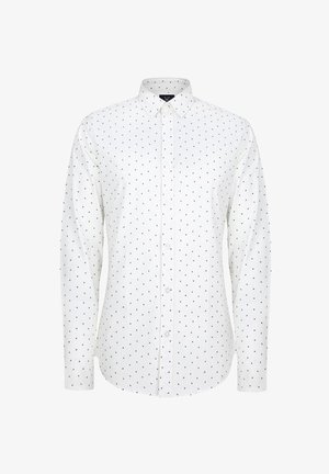 Biała koszula z długim rękawem i kołnierzykiem zapinanym na guziki, ozdobiona małymi czarnymi kropeczkami na całej powierzchni oraz prostym dołem. Guziki z przodu.