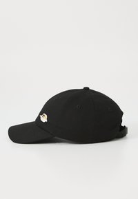 Black cotton baseball cap featuring a curved visor and an embroidered patch on the front. Adjustable strap at the back for fit.