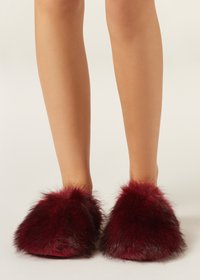Burgundy fur slippers with a fluffy texture and rounded shape, featuring a soft, plush upper and a flat sole.