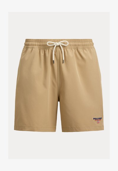 Béžové plavecké šortky s elastickým pásom a bielou šnúrkou, s malým logom Polo Sport Ralph Lauren na spodnej ľavej nohe.