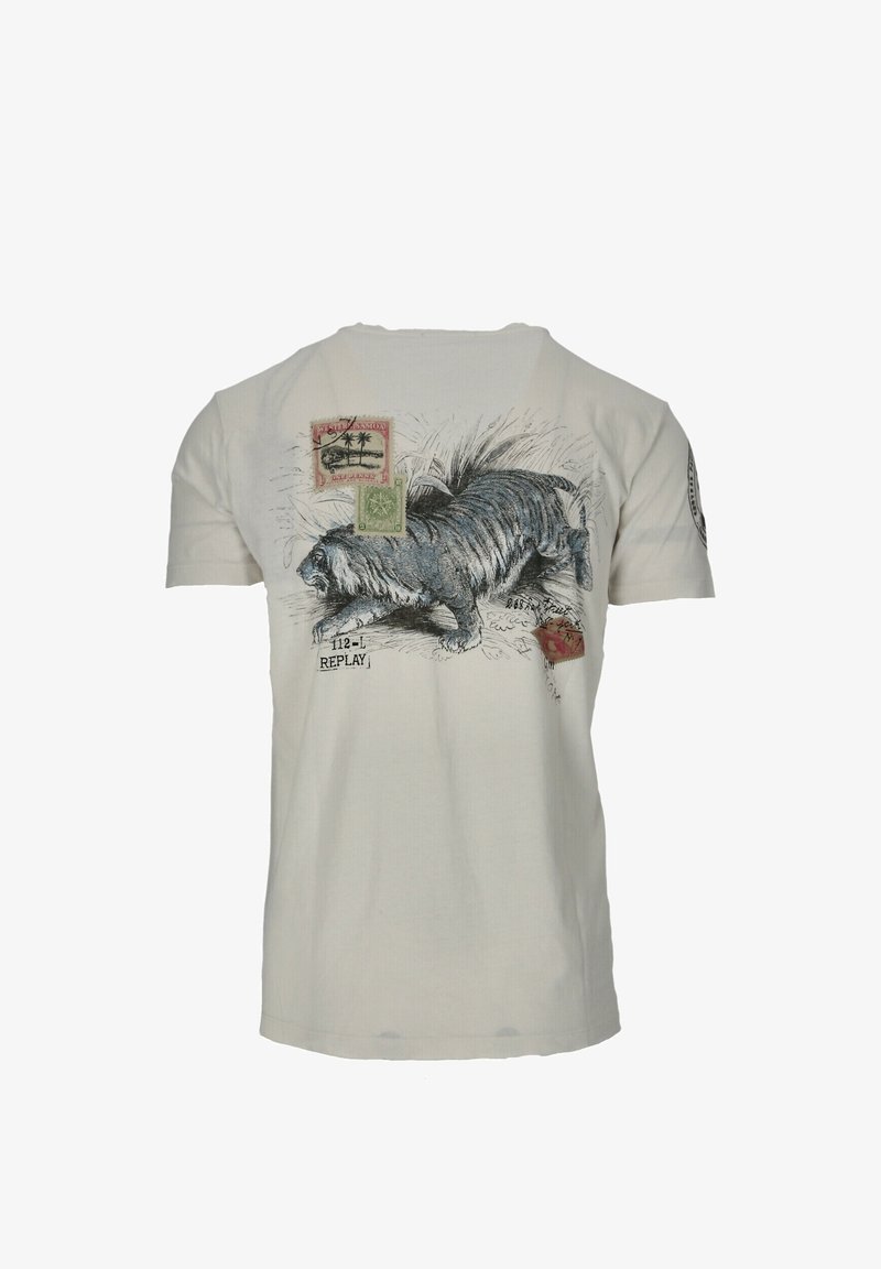 Valkoinen puuvillateepaita, jossa on kissan graafinen kuva, leimoja ja teksti. Paidassa on lyhyet hihat ja pyöreä pääntie.