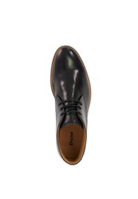 Black leather shoe with a smooth finish, rounded toe, lace-up design, and contrasting tan sole. Interior features brand name “Dune.”