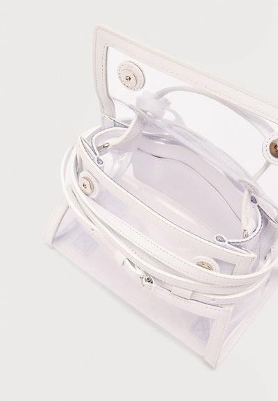 Διαφανής λευκή τσάντα με λευκά δερμάτινα στολίδια, μαγνητικά κλεισίματα και κορυφαία λαβή, εμφανιζόμενη ανοιχτή από πάνω.