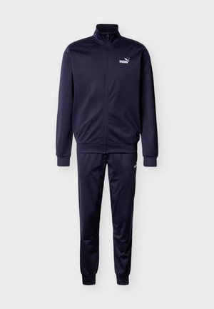 Mørkeblå træningsdragt i glat stof; har høj krave, fuld lynlås og ribstrikkede manchetter; inkluderer en hvid logo på brystet og låret.