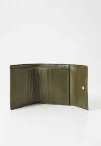 Olive green leather wallet with multiple card slots, smooth texture, a snap closure, and embossed logo on the interior.