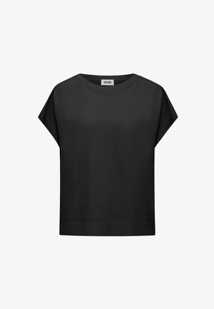 Chemise noire en coton à manches courtes avec un col rond et une étiquette "DRYKORN" à l'intérieur du col, présentée sur un fond blanc.