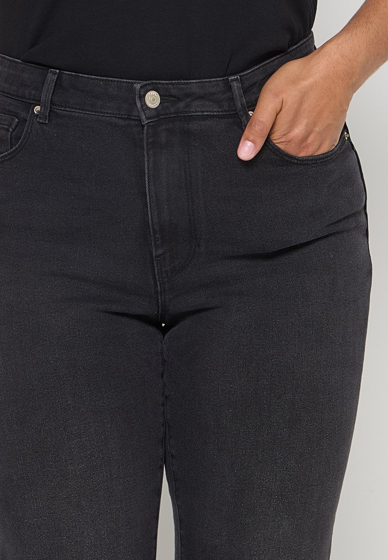 Schwarze Jeans mit hochgeschnittener Taille, ausgestattet mit Fronttaschen, einem sichtbaren Knopfverschluss und einer glatten Denim-Oberfläche.