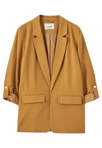 Blazer couleur moutarde avec un col classique, deux poches avant et des manches retroussées maintenues par des accents de boutons. Texture textile douce.