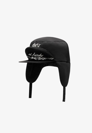 Black padded hat with wide brim, ear flaps, and snap closure. Features white embroidered logo and decorative pattern on the front.