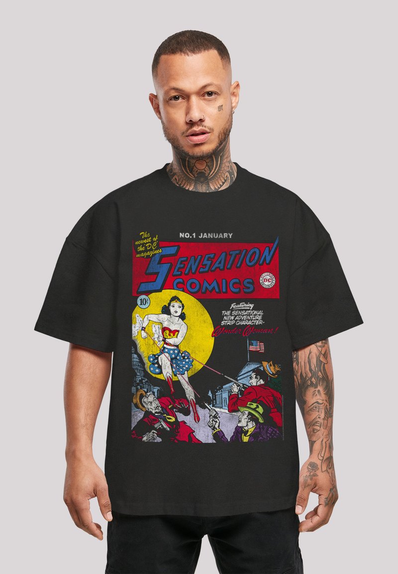 Black t-shirt featuring a vintage comic book cover with Wonder Woman, colorful graphics, and text in red and yellow on the front.
