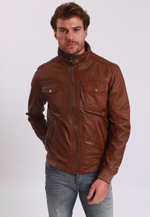 Chaqueta de cuero marrón con cierre de cremallera, dos bolsillos en el pecho, bolsillos laterales con cremallera y un cuello alzado con un acabado suave y texturizado.