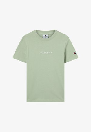 Light green cotton t-shirt with a crew neck, featuring "LOS ANGELES" and "CHAMPION" printed in white on the front, short sleeves.