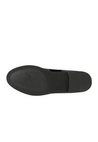 Black leather shoe with a flat, textured sole. Features a cut-out design, smooth finish, and embossed logo on the sole.