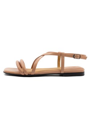 Tan flat sandals with three twisted straps and a buckle ankle strap. Smooth synthetic material and a flat black sole.