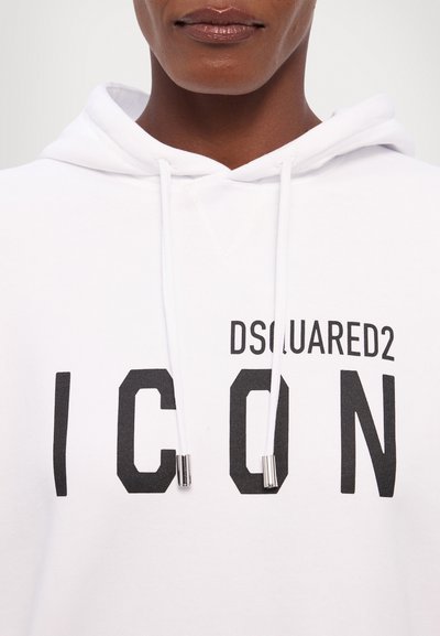 White hoodie made of cotton with black "ICON" text and brand name. Features drawstrings with silver aglets and a kangaroo pocket at the front.