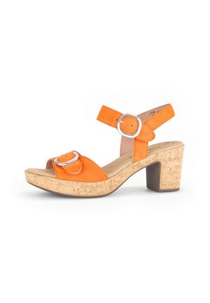 Orange suede heeled sandal with cork platform and block heel. Features two silver metal buckles on the straps. Open toe design.