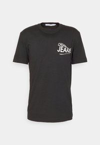 Black cotton T-shirt with short sleeves, featuring a white printed logo that reads "CALVIN KLEIN JEANS" on the left side.