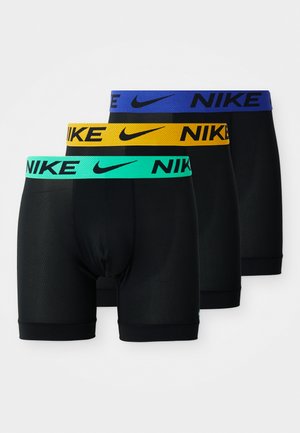Mustia bokserit, joissa on kontrastiväriset elastiset vyötärönauhat sinisen, vihreän ja keltaisen sävyissä, ja Nike-logo on selvästi näkyvissä.