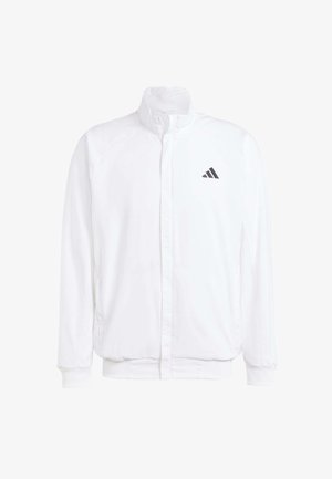 Bela lahka jakna s stojčnim ovratnikom, sprednjim zadrgo, stranskimi žepi in črnimi Adidasovimi logotipi na levem prsnem delu. Mehak material.