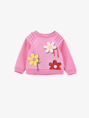 Felpa rosa con dettaglio a coste sulle spalle e applicazioni decorative in plastica a forma di fiore nei colori giallo, rosa e rosso, caratterizzata da dettagli di cucitura colorati.