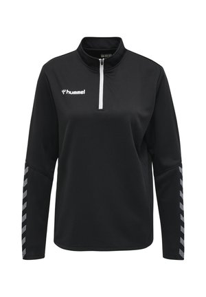 Haut de sport noir à manches longues avec une fermeture éclair blanche au quart, logo « hummel » sur la poitrine et bandes réfléchissantes en chevrons sur les deux manches.
