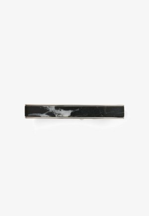 Black marble bar with white veining, rectangular shape, smooth surface, metal accents on edges, minimalist design, suitable for modern decor.