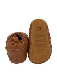 Chaussures pour bébé en cuir marron avec des semelles en daim souple, ouvertures élastiques et finition texturée. Présente des détails de couture et une étiquette de marque.