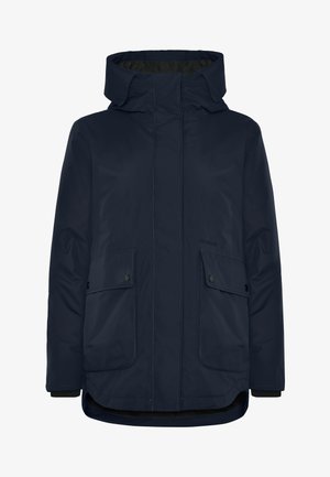 Marineblauwe geïsoleerde jas met een hoge kraag, ritssluiting aan de voorkant, twee klepzakken en een iets langere achterkant.