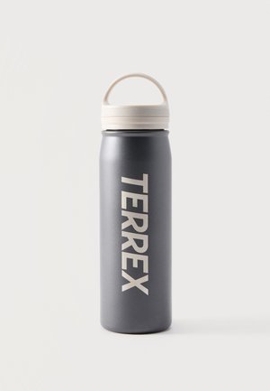 Bouteille d'eau gris foncé avec un couvercle à poignée blanche, placée debout, étiquetée "TERREX" verticalement en grandes lettres blanches.