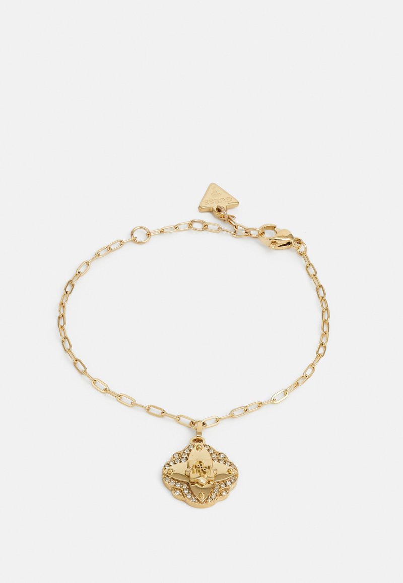 Gouden kettingarmband met een decoratieve hanger met een bloemenmotief en ingelegde heldere kristallen. Sluiting met een kreeftsluiting en een driehoekig label.