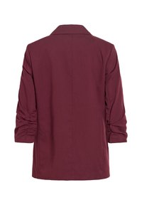 Blazer bordeaux à manches longues avec manches froncées, vu de dos sur fond blanc uni.