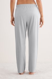 Lichtgrijze, zachte loungemouwen met een elastische tailleband, met een relaxte pasvorm en zijsplitten aan de zoom voor extra comfort.