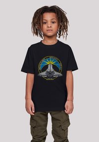 Black cotton t-shirt featuring a detailed graphic of the Space Shuttle Atlantis, with yellow and blue accents, in a relaxed fit.