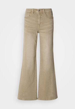 Beige vide jeans i slitesterk bomullsdenim, med knappelukking, fem-lomme design, og subtil sømdetalj langs sømmene.