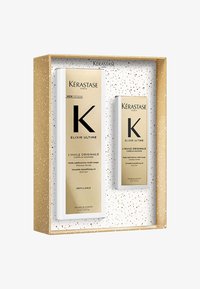 Set Kérastase Elixir Ultime en una caja dorada, que presenta dos botellas blancas con etiquetas doradas, mostrando patrones texturizados y un diseño elegante.