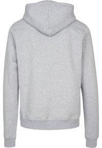 Grijze hoodie met een ribgebreide tailleband en manchetten, met een eenvoudig ontwerp en een zachte, textuurrijke fleece stof. Capuchon aan de achterkant.