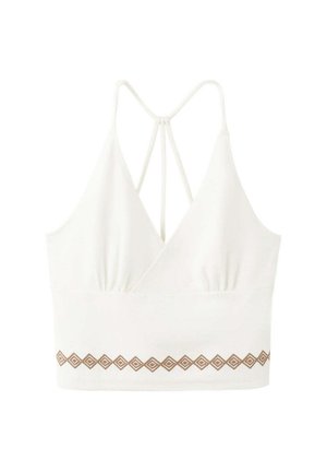 Crop top blanc avec fines bretelles, col en V, dos croisé et motif géométrique marron sur la bordure inférieure.