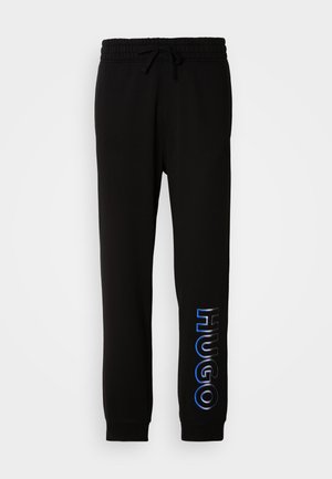 Mustad mustat spordipüksid, elastse kummiga vöökoht, pael, küljetaskud ja sinine "HUGO" logo vasakul jalal. Puuvilla segu materjal, mugav lõige.